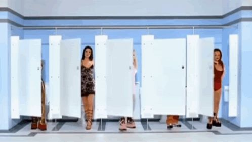 A Group Of Women Are Standing In A Row In A Bathroom GIF