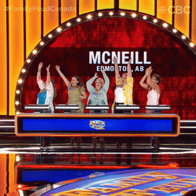 A Group Of Women Are Standing In Front Of A Sign That Says Mcneill On It GIF