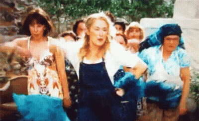 A Group Of Women Are Standing Next To Each Other And Dancing In A Field . GIF