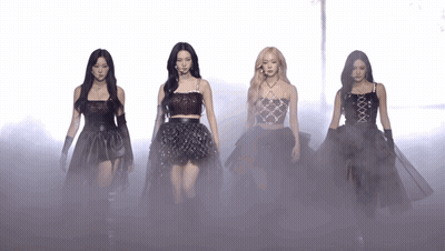 A Group Of Women Are Standing Next To Each Other In A Foggy Area GIF
