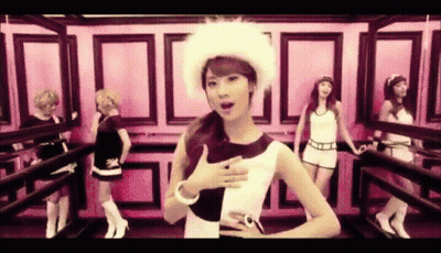 A Group Of Women Are Standing Next To Each Other In A Room . One Of The Women Is Wearing A Fur Hat . GIF