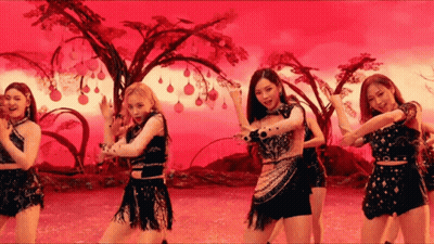 A Group Of Women Are Standing Next To Each Other In Front Of A Red Background . GIF