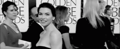 A Group Of Women Are Standing Next To Each Other On A Red Carpet At A Golden Globes Event . GIF