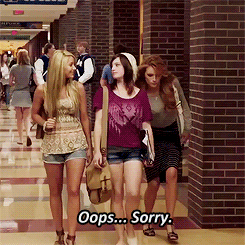A Group Of Women Are Walking Down A Hallway And One Of Them Is Saying Oops Sorry GIF