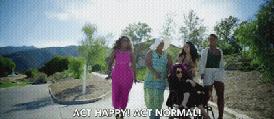 A Group Of Women Are Walking Down A Street With The Words Act Happy Act Normal Behind Them GIF