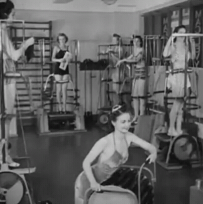 A Group Of Women Are Working Out In A Gym . GIF