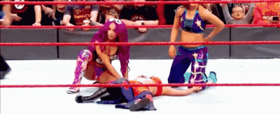 A Group Of Women Are Wrestling In A Ring While A Baby Is Watching . GIF