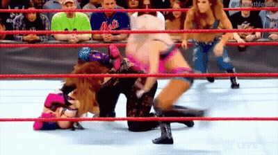 A Group Of Women Are Wrestling In A Ring While A Crowd Watches . GIF