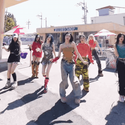 A Group Of Women Dancing In Front Of A Record Shop GIF