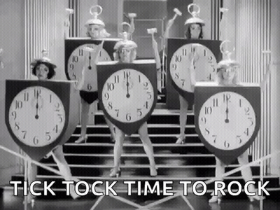 A Group Of Women Dressed As Clocks Are Dancing On Steps . GIF