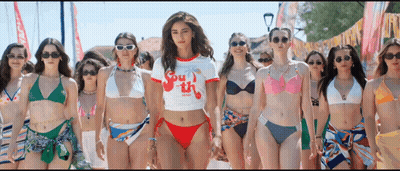 A Group Of Women In Bikinis Are Standing Next To Each Other On The Beach . GIF