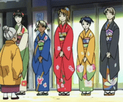 A Group Of Women In Kimonos Are Standing In A Line GIF