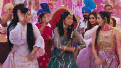 A Group Of Women In Traditional Dresses Are Dancing At A Party . GIF