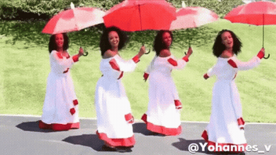 A Group Of Women In White Dresses Holding Red Umbrellas . GIF