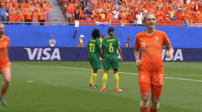 A Group Of Women Playing Soccer On A Field With A Visa Banner Behind Them GIF