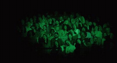 A Group Of Women Singing In Front Of Microphones On A Stage GIF