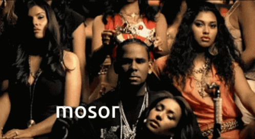 A Group Of Women Sitting Around A Man With The Word Mosor On The Bottom Right GIF