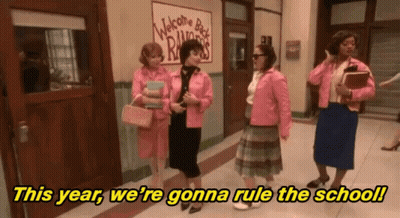 A Group Of Women Standing In A Hallway With The Words " This Year We 'Re Gonna Rule The School " In Yellow Letters GIF