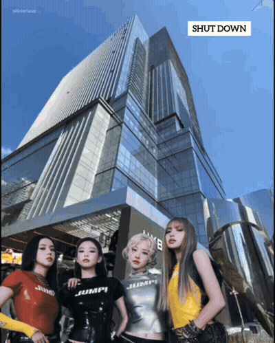 A Group Of Women Standing In Front Of A Building That Says " Shut Down " On It GIF