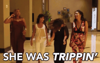 A Group Of Women Walking Down A Hallway With The Words She Was Trippin ' GIF
