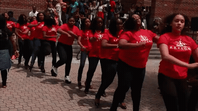 A Group Of Women Wearing Red Shirts With R.e.a.s.g.n. On Them GIF