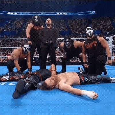A Group Of Wrestlers Are Posing For A Picture And One Of Them Is Wearing A Black Shirt That Says Mt GIF