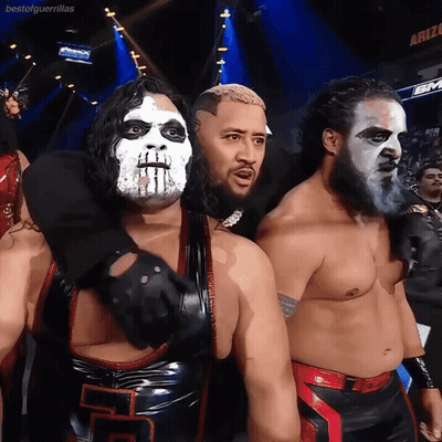 A Group Of Wrestlers Are Posing For A Picture In Front Of A Sign That Says Bestofguerrillas GIF