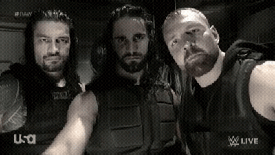 A Group Of Wrestlers Are Posing For A Picture In Front Of A U-S-A Logo GIF