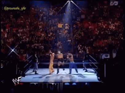 A Group Of Wrestlers Are Standing In A Ring With Fireworks Coming Out Of It GIF