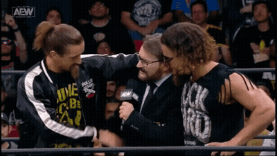 A Group Of Wrestlers Are Standing Next To Each Other In A Ring With A Aew Logo On The Bottom Left GIF