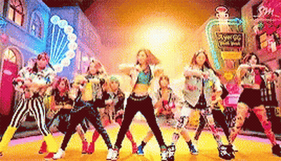 A Group Of Young Girls Are Dancing In Front Of A Perfume Bottle That Says Angel G GIF