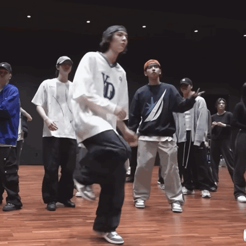 A Group Of Young Men Are Dancing And One Of Them Is Wearing A Shirt That Says Kd On It GIF
