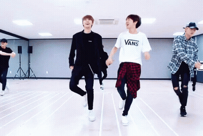 A Group Of Young Men Are Dancing In A Dance Studio And One Of Them Is Wearing A Vans T-Shirt GIF