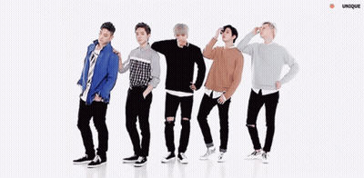 A Group Of Young Men Are Dancing In A Line With Their Arms Outstretched . GIF