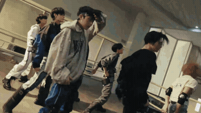 A Group Of Young Men Are Dancing In A Room And One Of Them Is Wearing A Hoodie That Says N.y.c. GIF