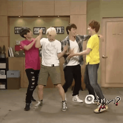 A Group Of Young Men Are Dancing In A Room And One Of Them Is Wearing A Yellow Shirt That Says ? GIF