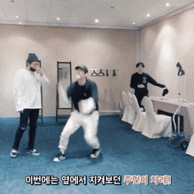 A Group Of Young Men Are Dancing In A Room With Foreign Writing On The Wall GIF