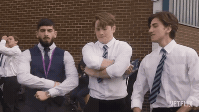 A Group Of Young Men Are Dancing In Front Of A Brick Building And The Word Netflix Is On The Bottom GIF