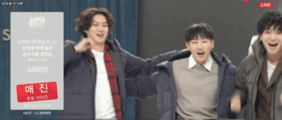 A Group Of Young Men Are Dancing In Front Of A Sign That Says Super Show GIF
