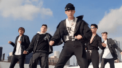 A Group Of Young Men Are Dancing On A Rooftop In Front Of A City Skyline GIF