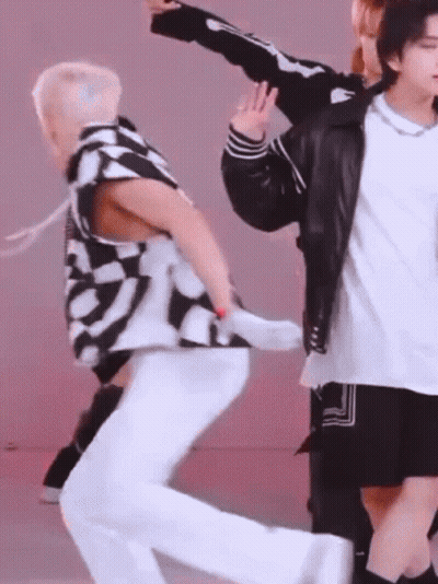 A Group Of Young Men Are Dancing Together And One Of Them Is Wearing A Skeleton Jacket GIF