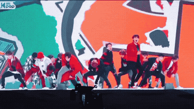 A Group Of Young Men Are Performing On A Stage With Asian Pop Written On The Bottom GIF