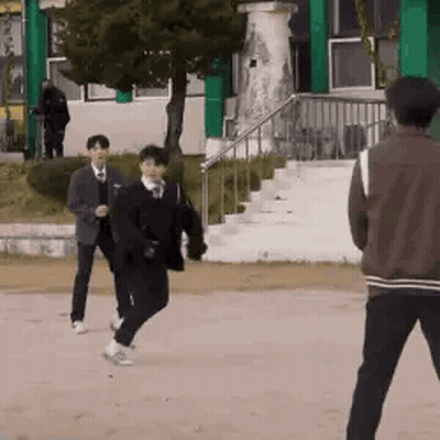 A Group Of Young Men Are Playing A Game Of Soccer On A Field . GIF