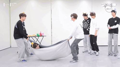 A Group Of Young Men Are Playing A Game With A Blanket That Says Hype GIF