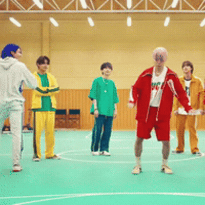 A Group Of Young Men Are Playing Basketball In A Gym And One Of Them Is Wearing A Shirt That Says Mc GIF
