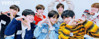 A Group Of Young Men Are Posing For A Picture And Making Hearts With Their Hands . GIF