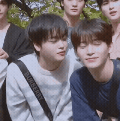 A Group Of Young Men Are Posing For A Picture And One Of Them Is Wearing A Burberry Sweatshirt . GIF