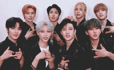 A Group Of Young Men Are Posing For A Picture And One Of Them Is Wearing A Necklace With The Letter G On It GIF