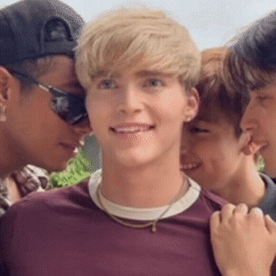 A Group Of Young Men Are Posing For A Picture . One Of The Men Is Wearing Sunglasses . GIF