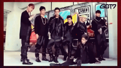 A Group Of Young Men Are Posing In Front Of A Sign That Says Asto GIF